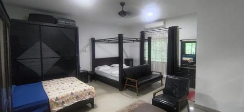 a bedroom with a bunk bed and a chair at DD Empire Homestay in Kuala Selangor