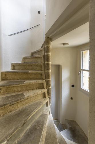 a stone staircase in a house with a window at My Hotel Peyrou - Premiere conciergerie in Montpellier