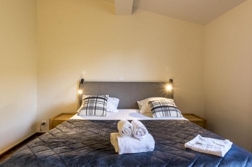 a bedroom with a bed with towels on it at My Hotel Peyrou - Premiere conciergerie in Montpellier