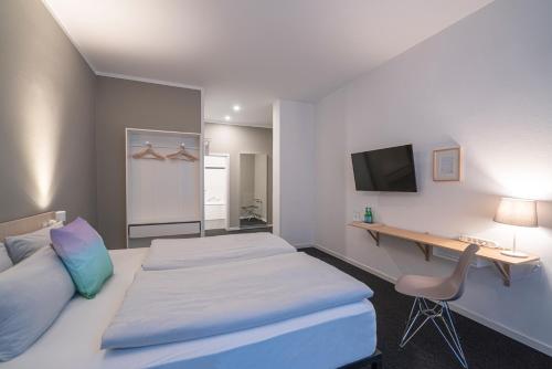 a hotel room with a bed and a desk at BIG MAMA Leipzig in Leipzig