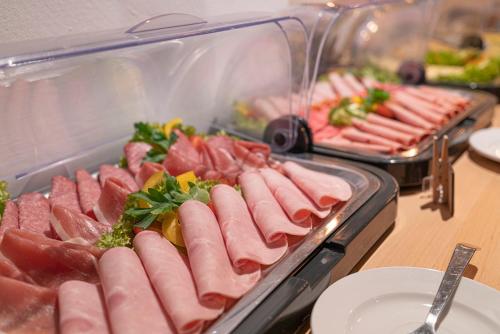 a bunch of different types of meats on a buffet at BIG MAMA Leipzig in Leipzig