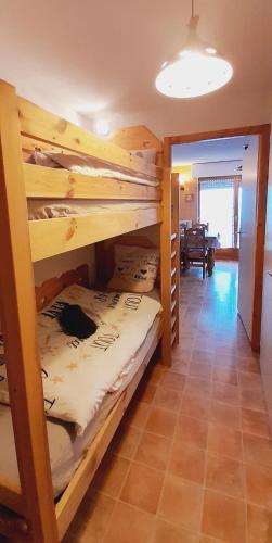 a room with four bunk beds in a house at Le coeur des Memises in Thollon