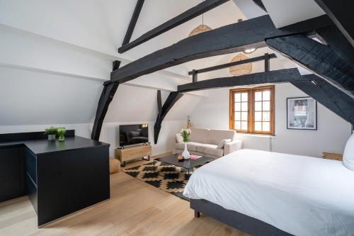 a bedroom with a large bed and a living room at Smartflats - Grand-Place II in Brussels