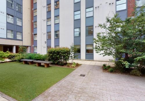 a courtyard with benches in front of a building at Tufnell House in London in London