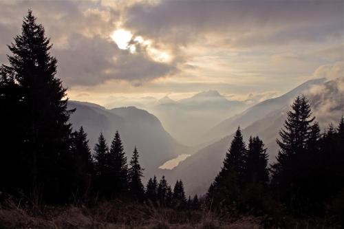 a view of a mountain valley with the sun setting at Micro-lodge, Le Petit Nid d'Amour in Montriond