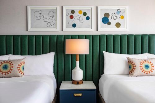 a bedroom with two beds and a lamp on a night stand at The Royal Sonesta Chicago Downtown in Chicago