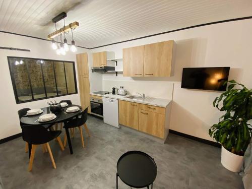 a kitchen with a table and chairs and a kitchen with a table and a kitchen at Appartement chic et cosy au pied du village in Villard-de-Lans