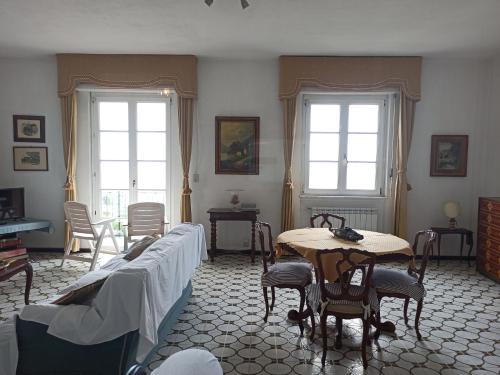 a living room with a table and a couch at Poggio dei sogni in Rapallo