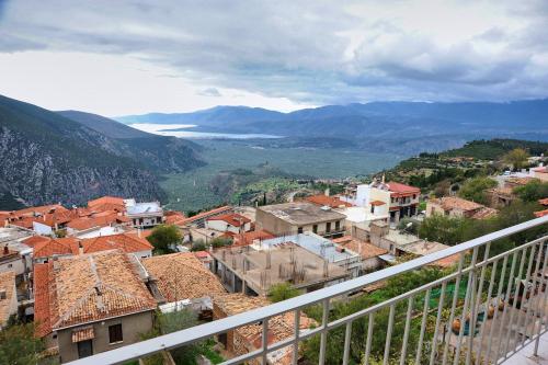 a view of a town from a balcony at Castri Hotel in Delfoi
