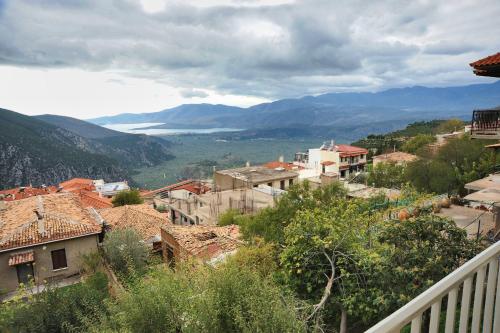 a view of a town with mountains in the background at Castri Hotel in Delfoi