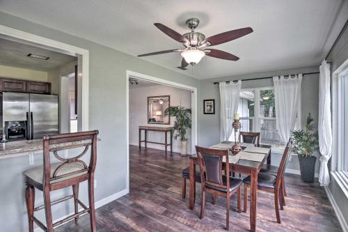 a dining room with a ceiling fan and a table and chairs at Deltona Lake House, Day Trip to Disney and Universal in Deltona