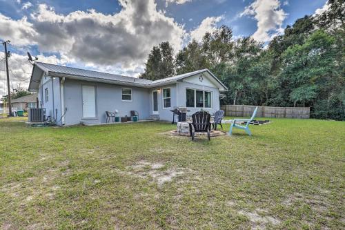a white house with a table and chairs in a yard at Deltona Lake House, Day Trip to Disney and Universal in Deltona