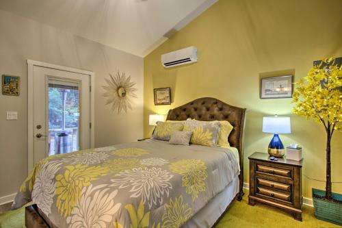 a bedroom with a bed and a table with a lamp at 13 Mi to Camelback Ski! Creekside Lincoln Lodge in Brodheadsville
