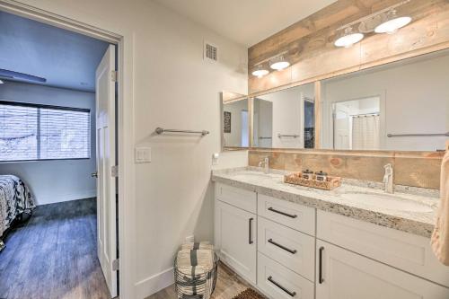 a bathroom with two sinks and a large mirror at Cabin 404 - Payson Getaway with Deck and Mtn Views! in Payson