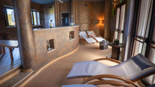 a hallway with chairs and a mirror in a room at Relais Bella Rosina Pool & Spa in Fiano