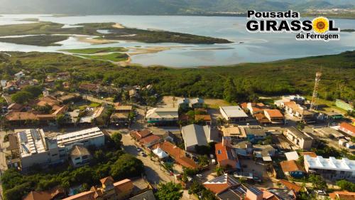an aerial view of a small town next to a river at Pousada Girassol da Ferrugem in Garopaba