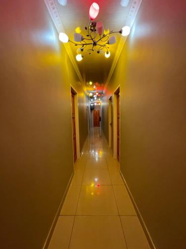 a hallway with a ceiling with a chandelier at Mohlakeng Guest House in Randfontein