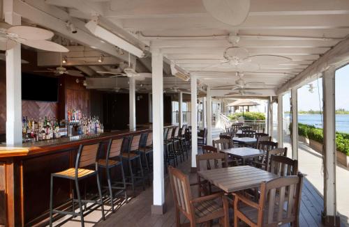a restaurant with tables and chairs and a bar at Pier House Resort & Spa in Key West