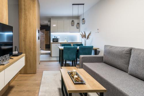 a living room with a couch and a table at Daisy resort in Novi Sad