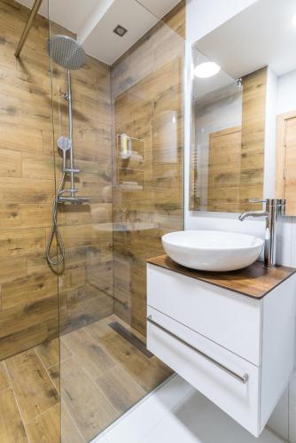 a bathroom with a sink and a shower at Daisy resort in Novi Sad