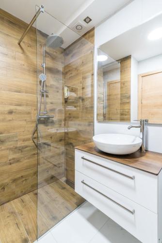 a bathroom with a sink and a shower at Daisy resort in Novi Sad
