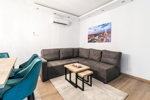a living room with a couch and a table at Daisy resort in Novi Sad