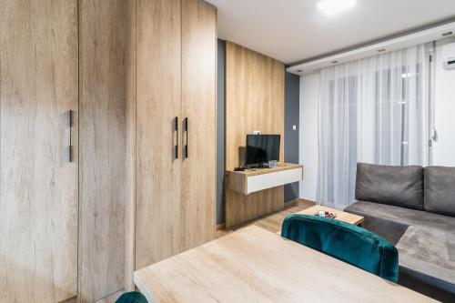 a living room with a couch and a table at Daisy resort in Novi Sad