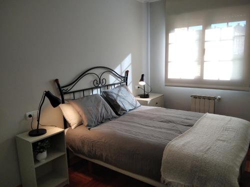 a bedroom with a large bed and a window at JARDINES DE VINJOY in Oviedo