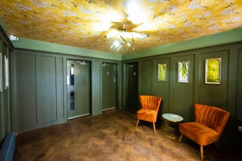 a room with two chairs and a ceiling at Sallow Tree House Self Catering in Selby