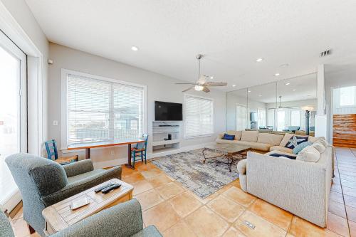 a living room with a couch and chairs and a tv at Lund - Nordic Villas in Orange Beach