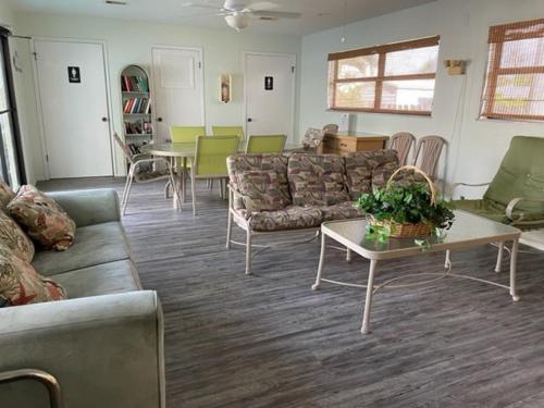a living room with couches and a table and chairs at Tuckaway Shores Resort in Melbourne