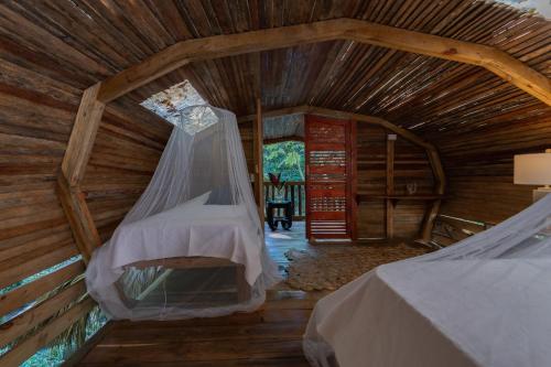 an attic room with a bed and a window at El Valle Lodge in El Valle