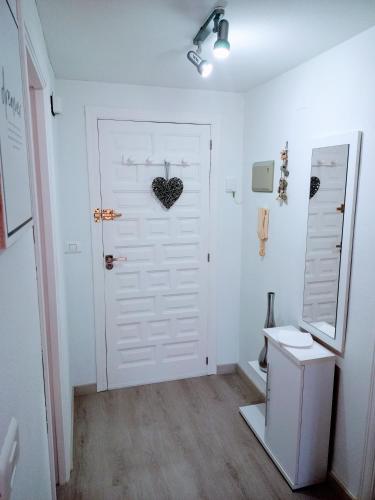 a white door with a heart hanging on it at Apartamento El Príncipe in Peniscola