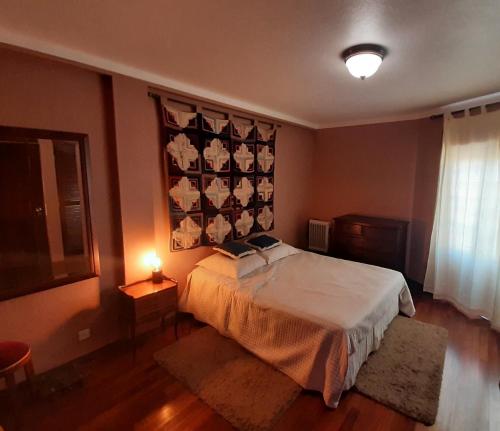 a bedroom with a bed and a wall with a flag at Parfum de la Mer in Sines