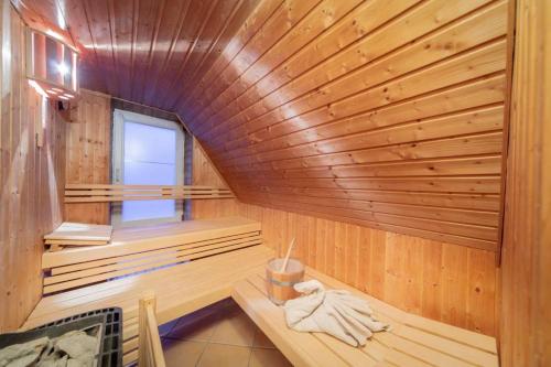 a wooden sauna with a bench and a window at Beach 1 in Rettin