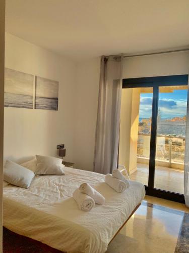 a bedroom with a bed with towels on it at SEA & CASTILLO VIEW in Castillo de Sabinillas