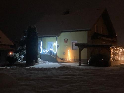 a building with christmas lights on it at night at Ferienwohnung Wittenburg in Hermagor