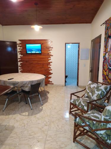 a living room with a table and two chairs at Casa de Praia Picinguaba in Ubatuba