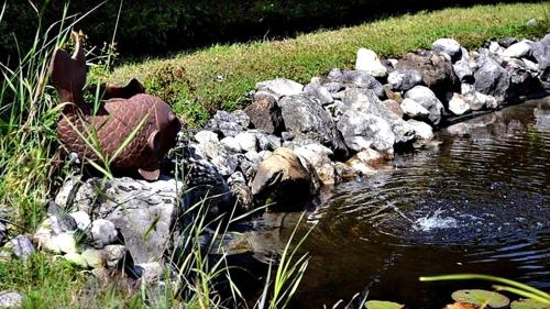 a pile of rocks next to a stream of water at Alpinferienwohnung Neuhuber in Bad Goisern