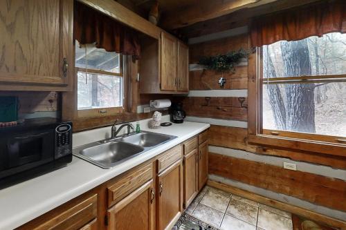 a kitchen with a sink and a microwave at Misty View Cabin in Hatchertown