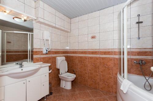 a bathroom with a toilet and a sink and a shower at Holiday Home in Komarna