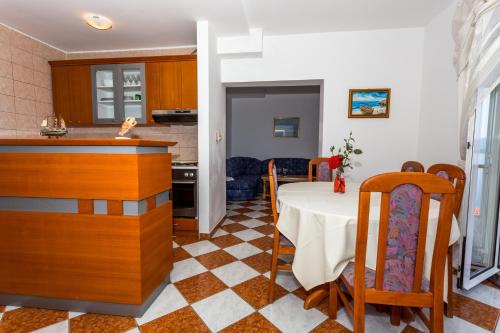a kitchen and a dining room with a table in a room at Holiday Home in Komarna