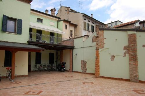 a group of buildings with bikes parked in the courtyard at Abbazia Bed & Breakfast, MantegnaHotels in Mantova