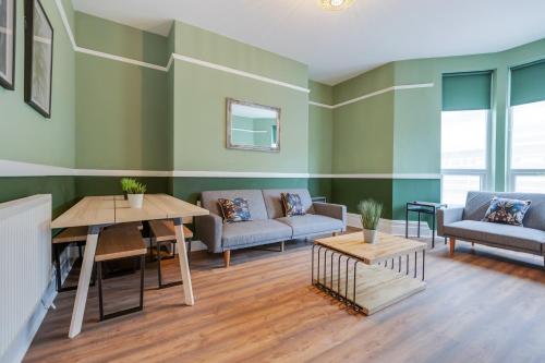 a living room with a couch and a table at Queen Street Apartments by Sasco in Blackpool