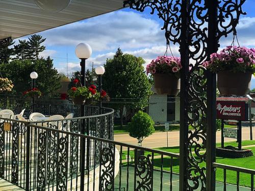 a wrought iron gate with chairs and potted plants at Amber's Inn and Suites in Wisconsin Dells