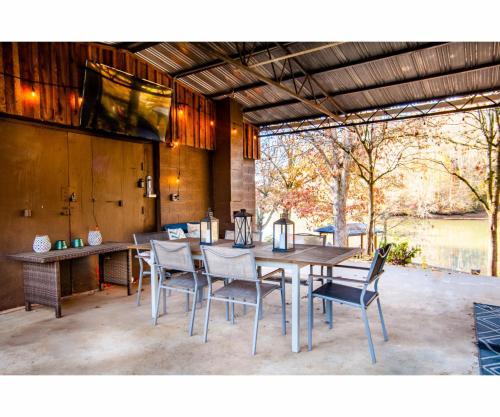 a dining room with a table and chairs at Classic Lake House Lakefront with Fire Pit and Dock in Louisville