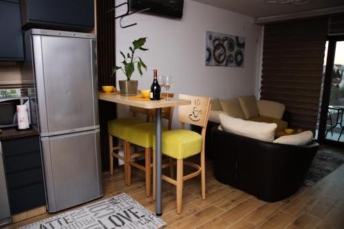 a kitchen with a small table and a couch at Avenija in Kragujevac