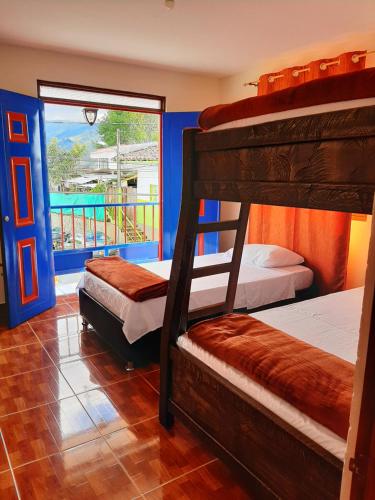 - une chambre avec 3 lits superposés et un balcon dans l'établissement Km0 Hostel, à Salento