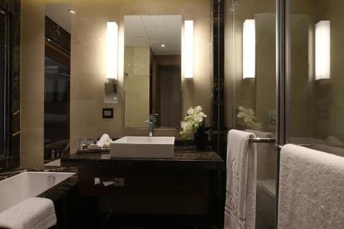 a bathroom with a sink and a mirror at Lancaster Plaza Beirut in Beirut