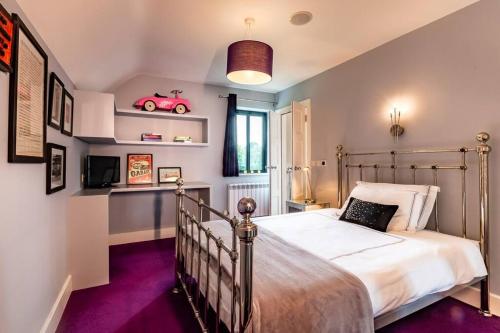a bedroom with a bed and a car on shelves at Luxury Country House on the Hill in Kenmare